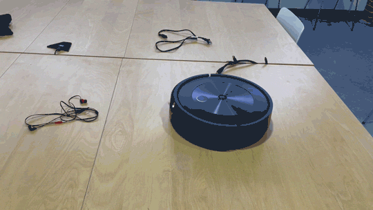 The iRobot Roomba j7+ turning away from headphone wires.