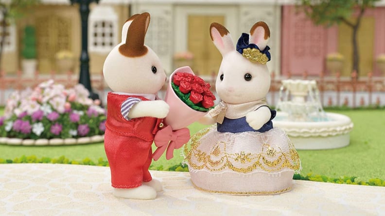 Bunny figurines exchanging flowers.