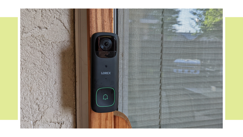 The Lorex 2K wireless doorbell hanging on the side of a home