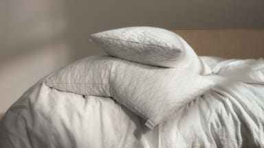 Coop Home original pillows sit on top of a bed