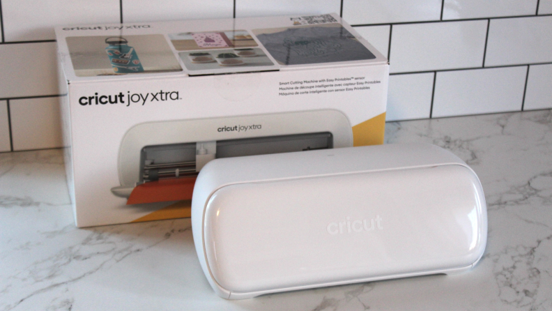 The Cricit Joy Xtra unboxed, sitting next to its packaging.