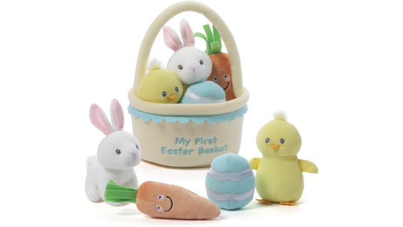 A plush Easter basket with a stuffed toy rabbit, duckling, Easter egg and carrot.