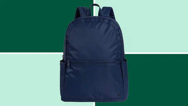 State Kane Double Pocket Backpack on a dark and light green background.