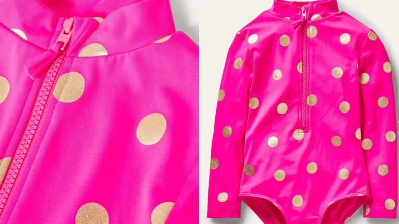 A bright fuschia bathing suit with gold dots and long sleeves