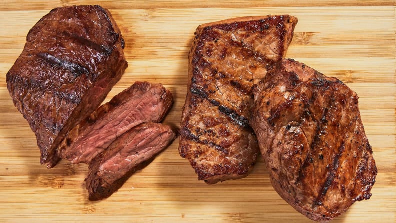 Cooked steak on a wooden cutting board