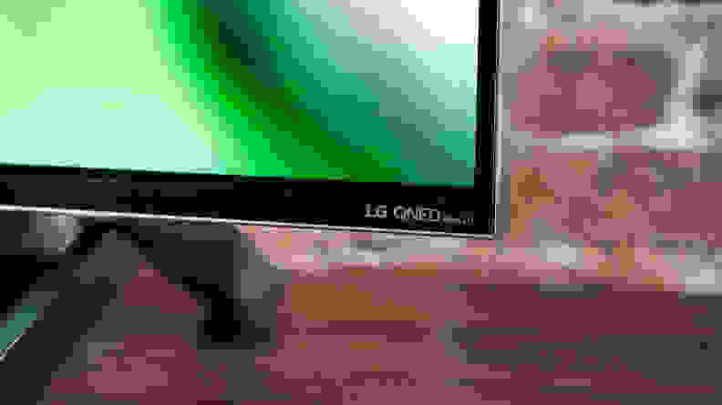 A close-up of the LG logo on the front of the LG QNED99 8K TV