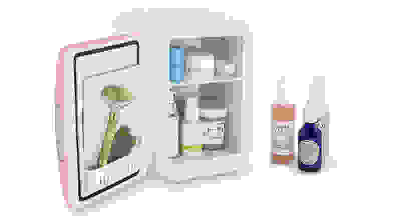 A miniature fridge open to reveal skincare products.