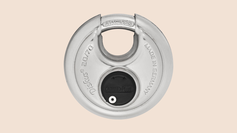 ABUS Diskus disk padlock against a plain beige background