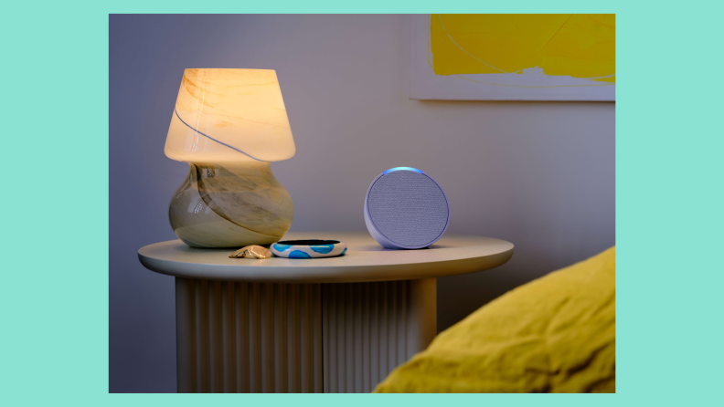 The Echo Pop smart speaker pictured on a nightstand