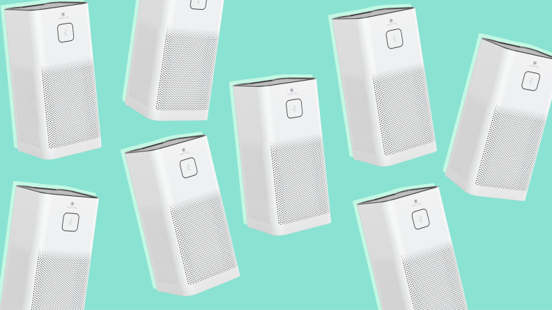 A series of white air purifiers against a green background.