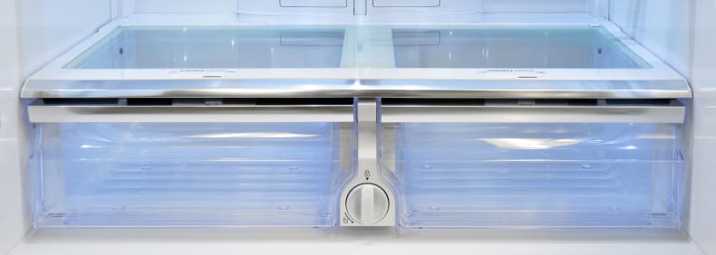 The Samsung RF23J9011SR's two adjustable crispers are more than up to task of preserving fresh produce. The fridge's water filter is located between them.