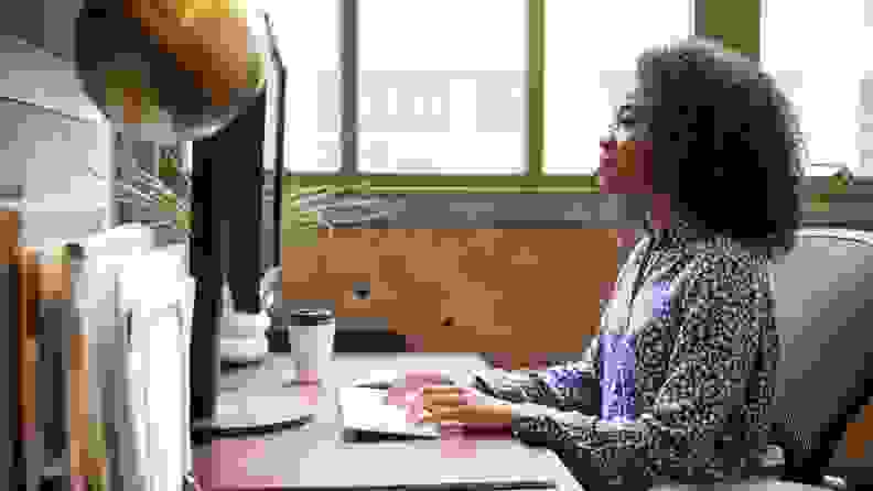 Businesswoman at her desk office looking at computer