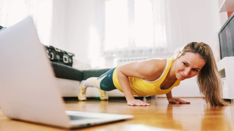 A woman taking an online yoga class.