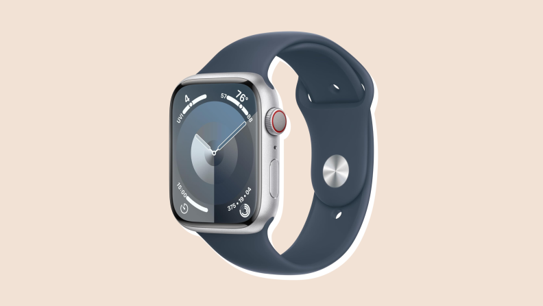 A silver-bezel Apple Watch in blue navy band with the face set to a blue background.