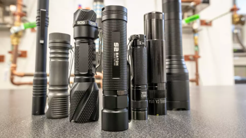 Stack of flashlights we have tested on table