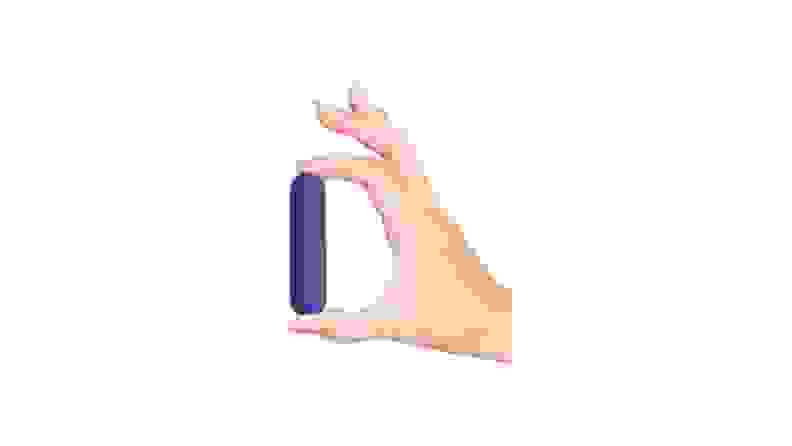 A hand holding a plusOne Bullet Vibrator in front of a white background.