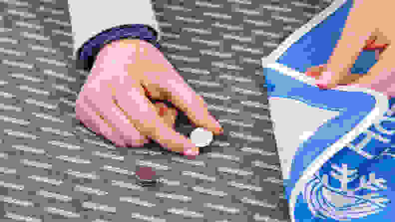 A person putting a heat sensor onto the Tuft & Needle Mint hybrid mattress.