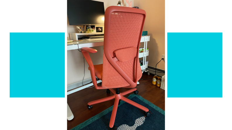Coral colored Verve Chair stationed at desk inside of modern home office.