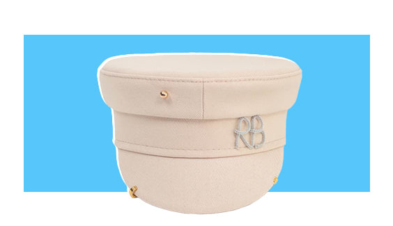 A cream-colored hat with gold piercings.