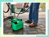 Person pouring gas from pump directly into green plastic gas can.