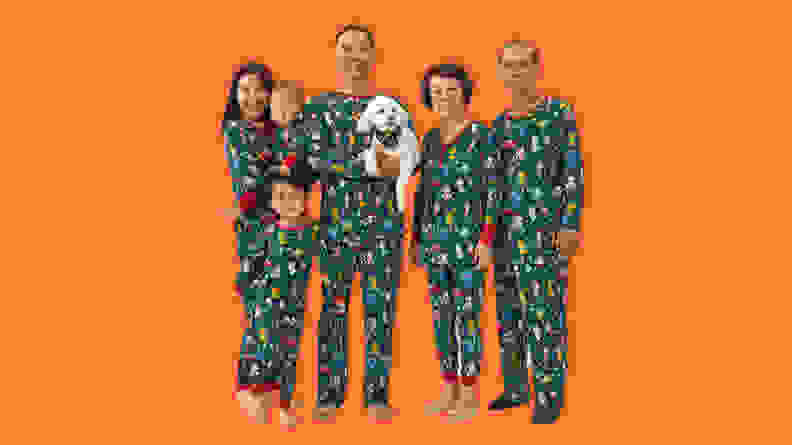 A family wearing Little Sleepies Disney Christmas Party matching family Christmas Pajamas.