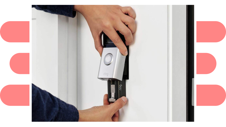 A person handling a video doorbell's battery pack.
