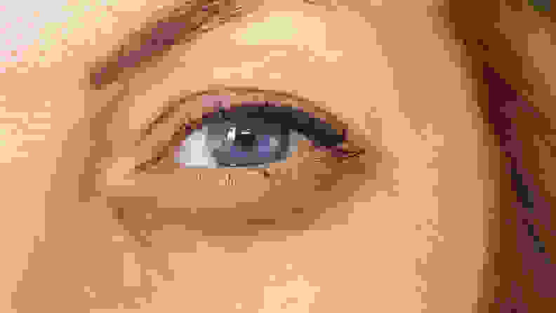 The left eye of a woman looking directly at the camera.