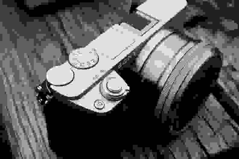 The A6000 has a three dial setup, with two dials for control (one on top and one on back) and a mode dial.
