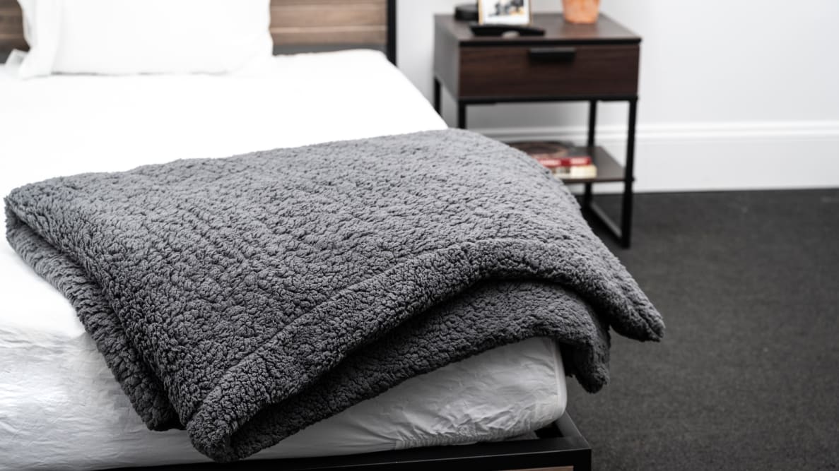 The Yaasa Signature weighted blanket sits on the foot of a bed