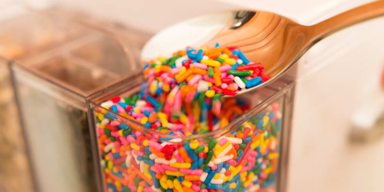 Toppings like these rainbow funfetti sprinkles are best for the front mix-in container, which has the smallest opening.