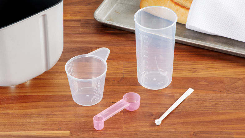 A set of measuring cups and spoons that come with the bread maker.