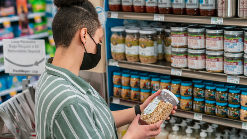 A person reads nutritional value on a packaged product.