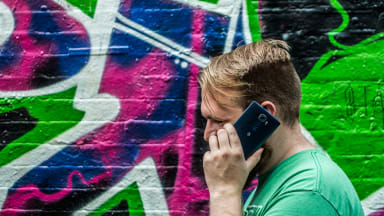 A man talking on an LG G4 smartphone