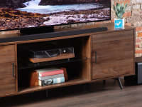 The Samsung HW-S800D Soundbar placed on top of a TV table and right below a flatscreen.
