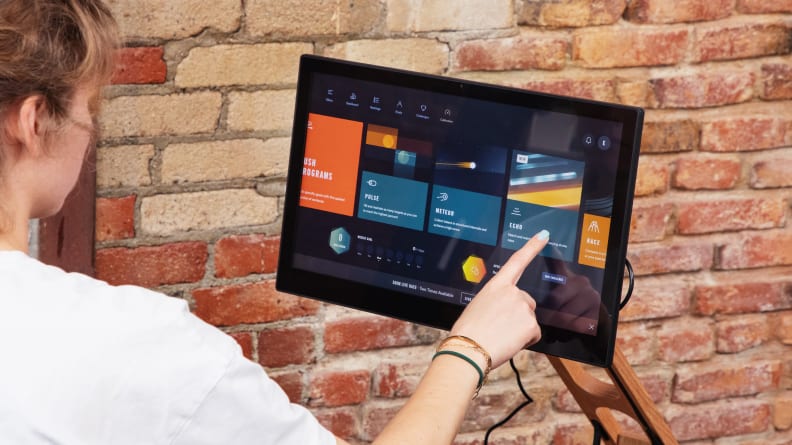 Woman touching the Ergata Lite screen.