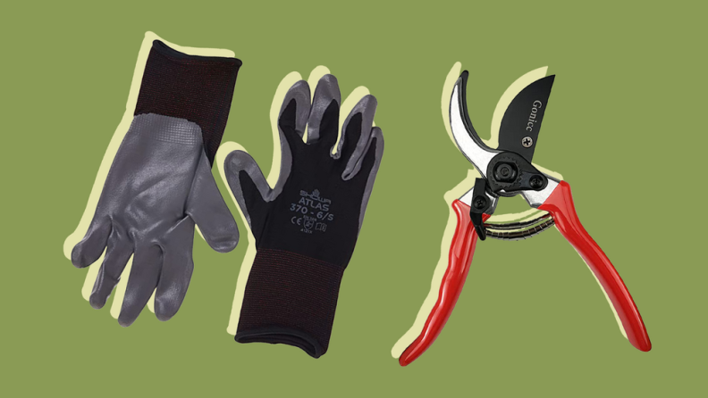 Two gray and black pruning gloves beside a pair of gardening shears.