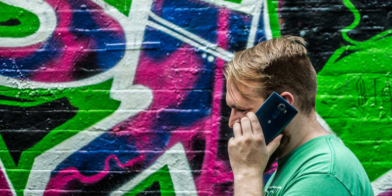 A photo of someone talking on their smartphone.