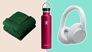 A green blanket, red Hydro Flask bottle, and white headphones from Amazon.