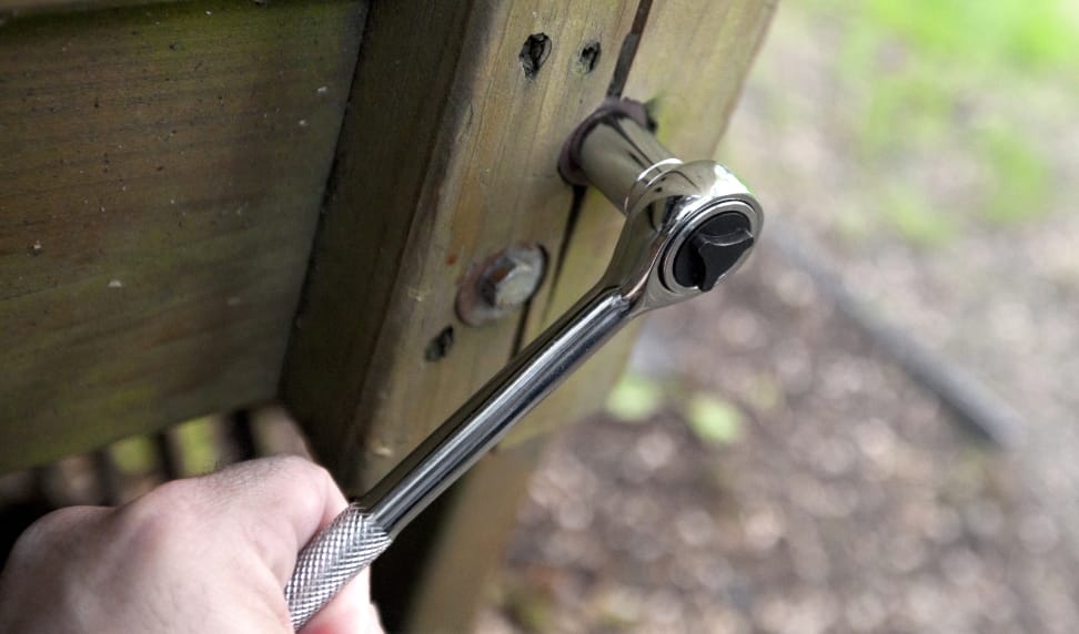 Tightening a lag bolt with a ratchet and socket