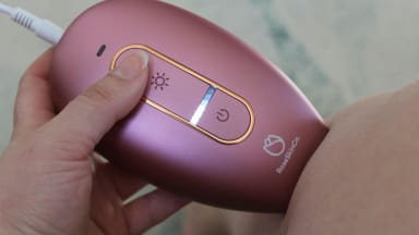 The RoseSkinCo Lumi permanent hair removal device being used on someone’s leg.