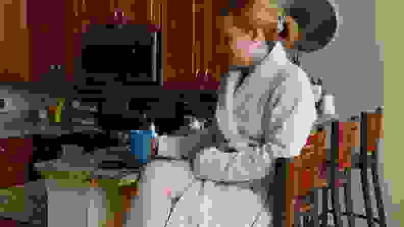 woman wearing white colored robe in living room