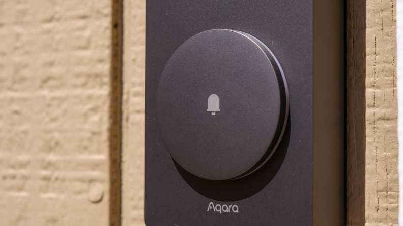 A close-up view of the Aqara Video Doorbell press button