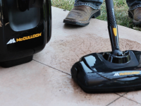 A model demonstrates the usefulness of a McCulloch steam cleaner on outdoor tile.