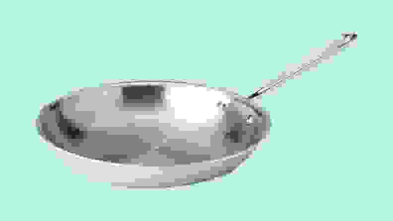 An All-Clad frying pan against a blue background.