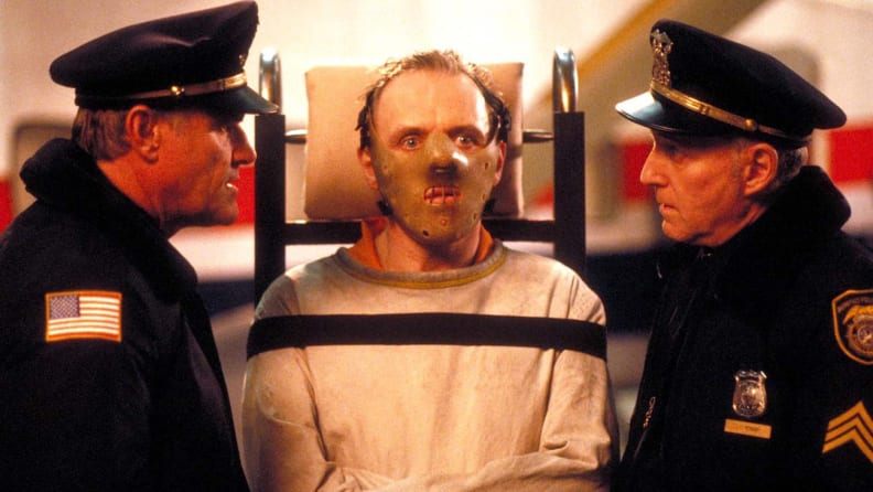Anthony Hopkins as Hannibal Lecter, surrounded by police officers, in "Silence of the Lambs" (1991), one of the best thrillers streaming now.