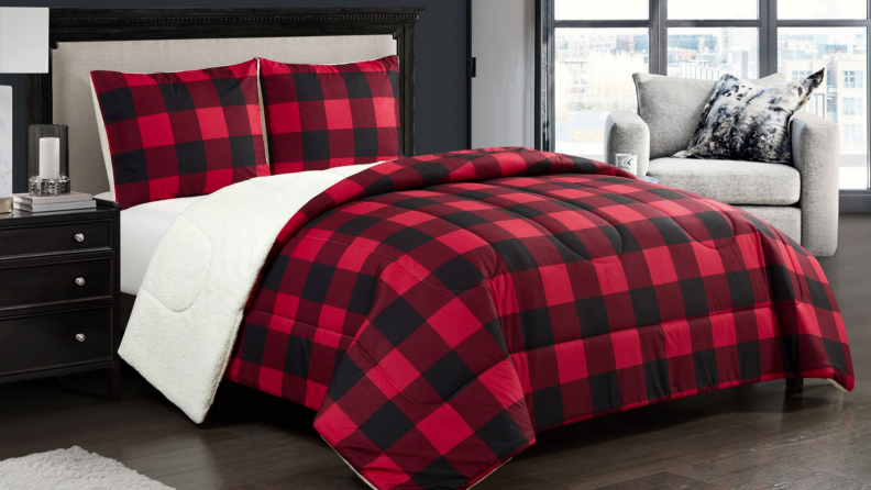 An image of a bed set with sherpa-lined red plaid blankets and pillowcases.