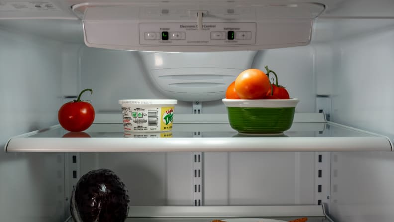 A close-up picture of the upper shelves of the fridge, which holds some fresh fruit.