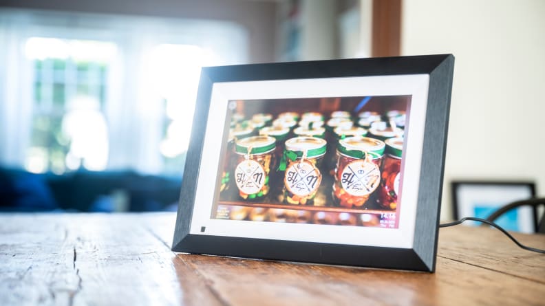 The Bsimb digital picture frame displays a colorful picture of wedding favors.