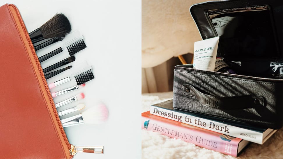 On the left: A red cosmetic bag laying flat with makeup brushes coming out of it. On the right: A black cosmetic bag with a moisturizer tube popping out of it sits on top of two books.