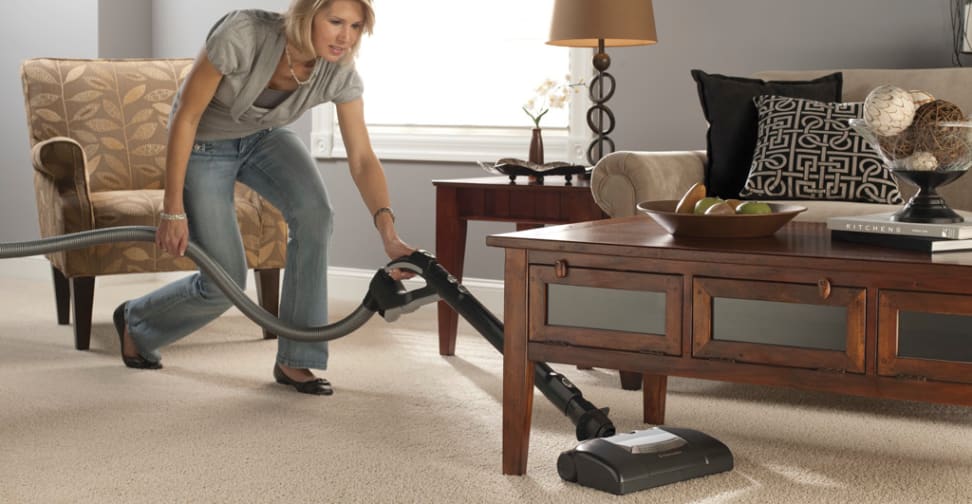 A woman vacuuming a living room